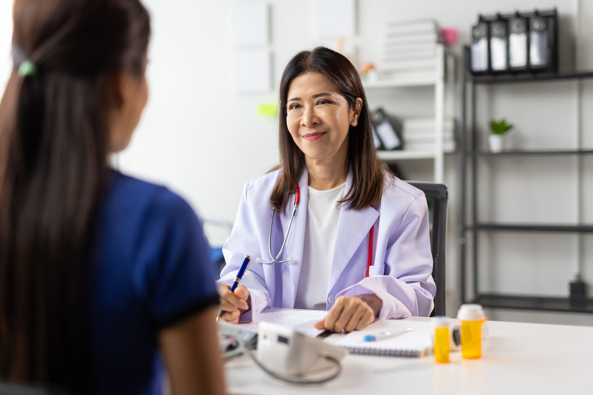 Female doctor explaining diagnosis to her patient during medical consultation