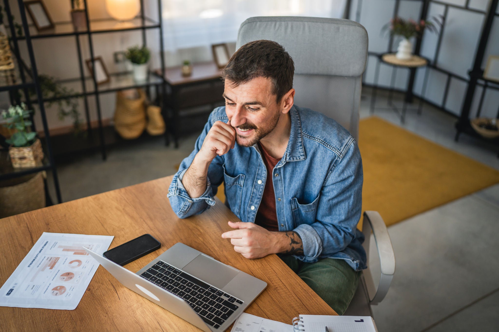 Adult man work on laptop and have video call meeting at home office