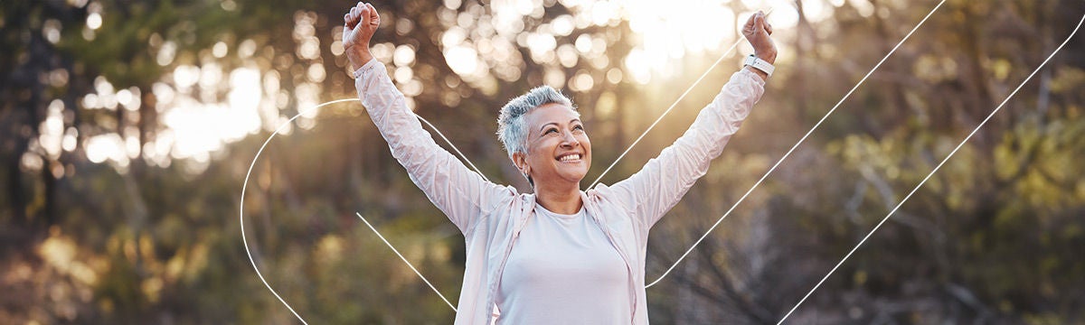Happy woman smiling and raising her arms