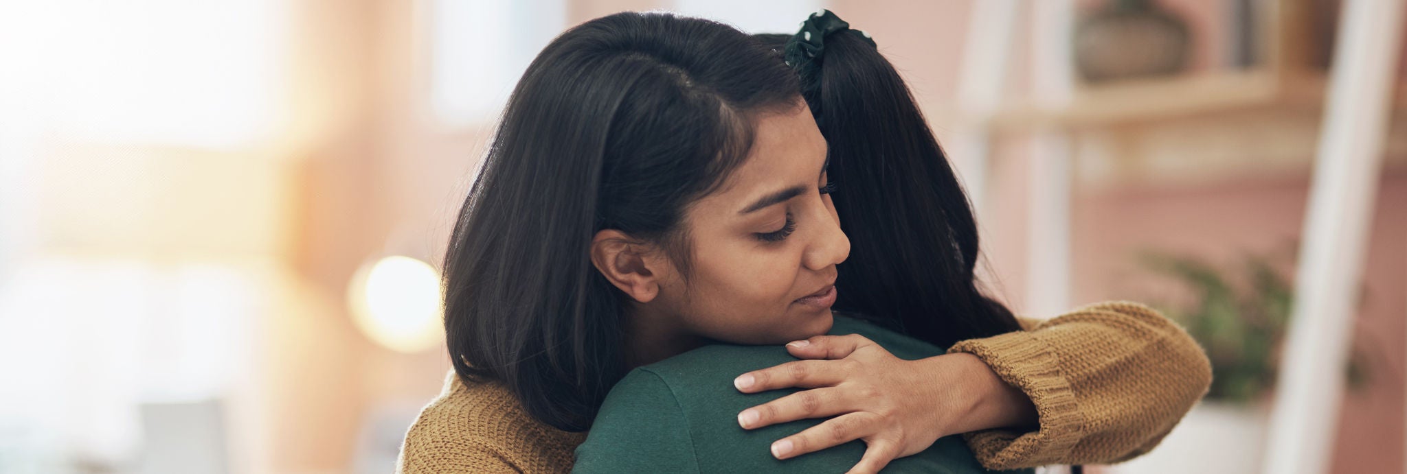 Two young women embracing each other 