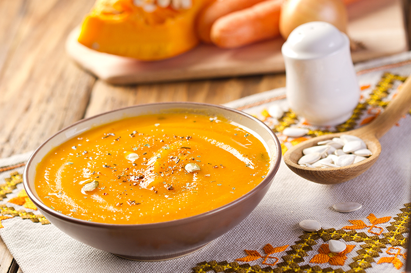 Vegan creamy pumpkin soup on a table, recipe