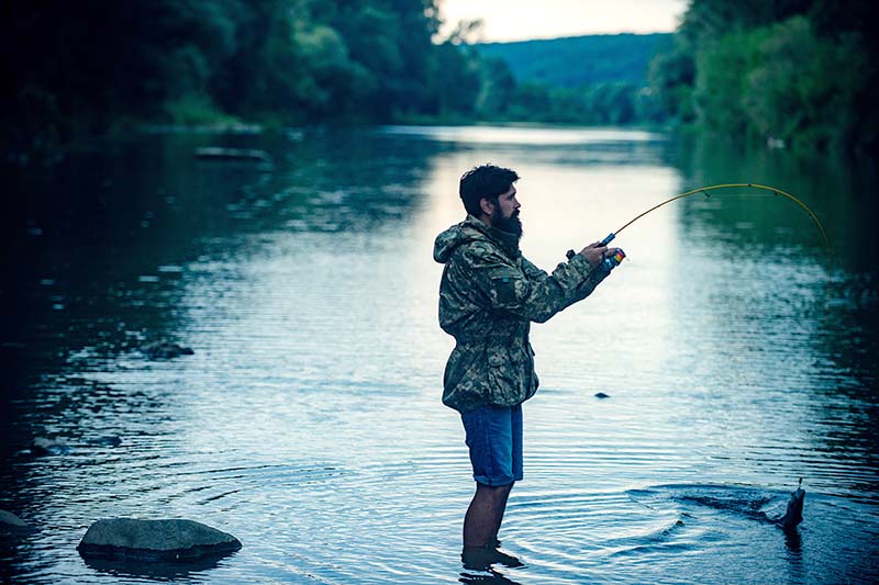 Man being mindful and relaxing while fishing.