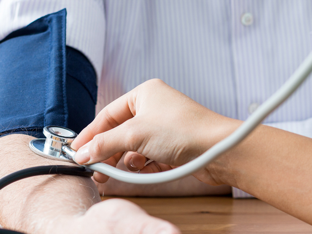hands taking someone's blood pressure