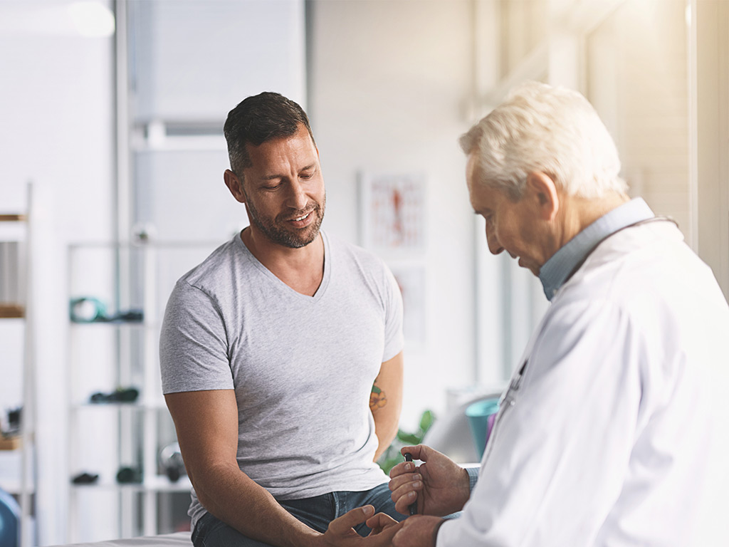 Photo of a man visiting his doctor for his regular Diabetes checkup.