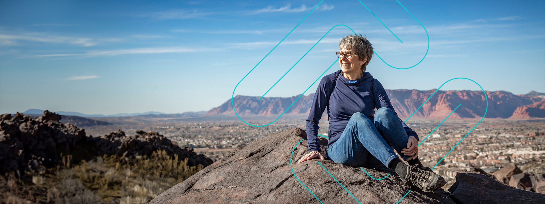 woman sitting on rock in utah mountains