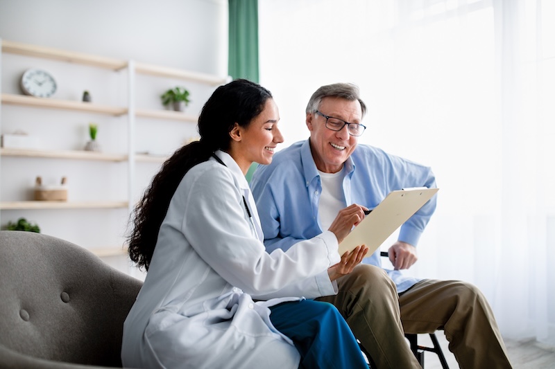 elderly male discussing a chart with a female doctor