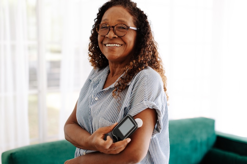 Woman checking her diabetes wearable device