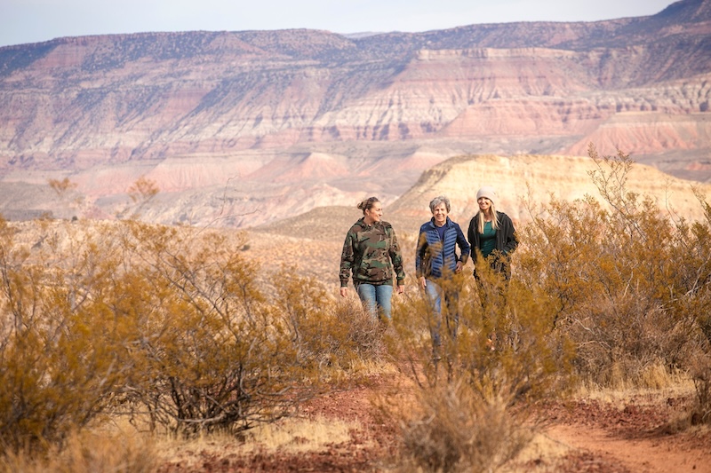 three women walking in desert