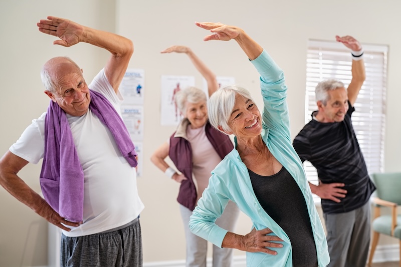 A group of seniors doing a yoga class