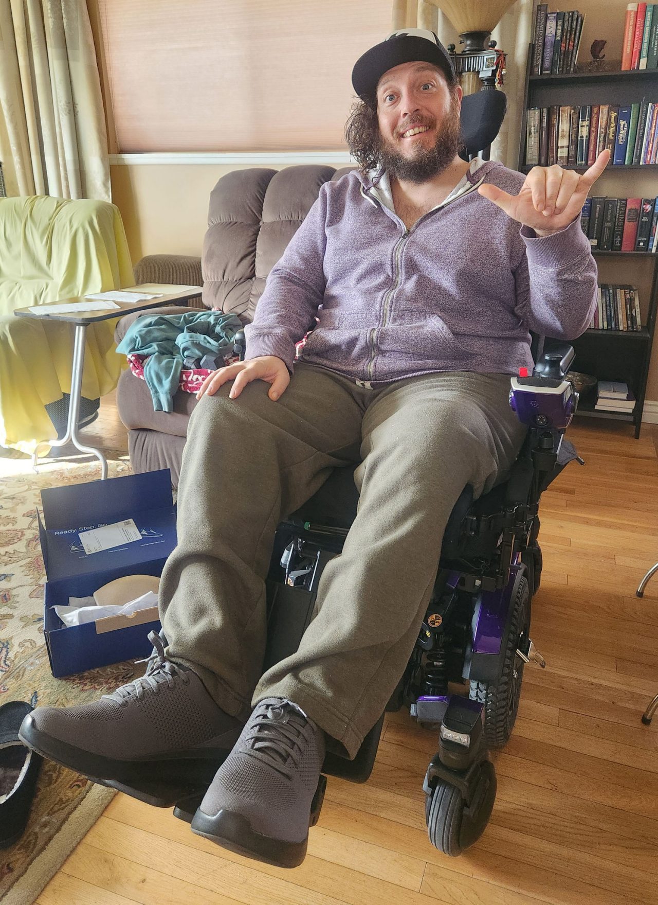 Martin is in his wheelchair smiling for the camera.