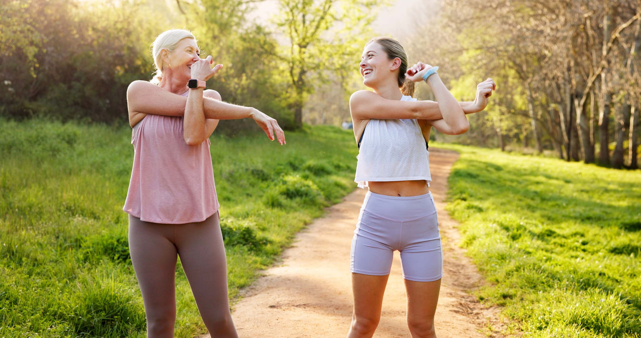 Fitness, stretching and mother with girl in nature for workout, outdoor exercise and wellness for health. Mature mom, daughter or women in park for training, sports routine or warm up.