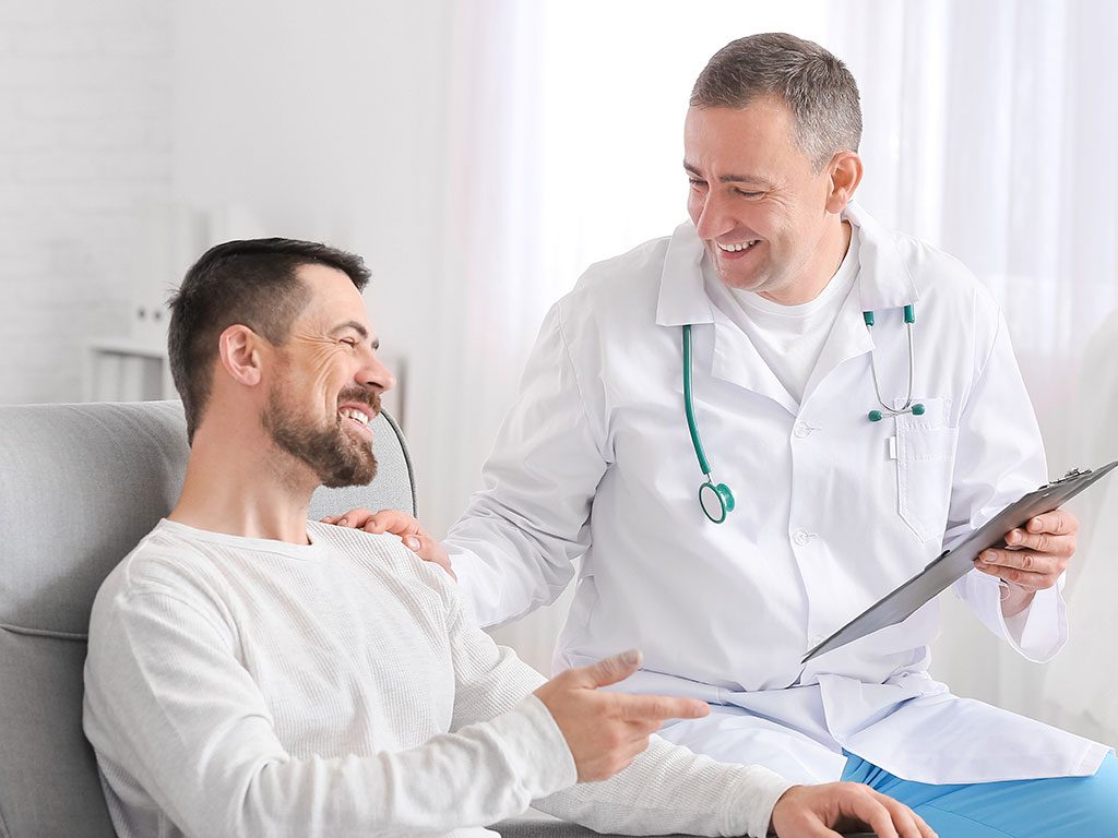 Doctor speaking with a male patient in a clinic